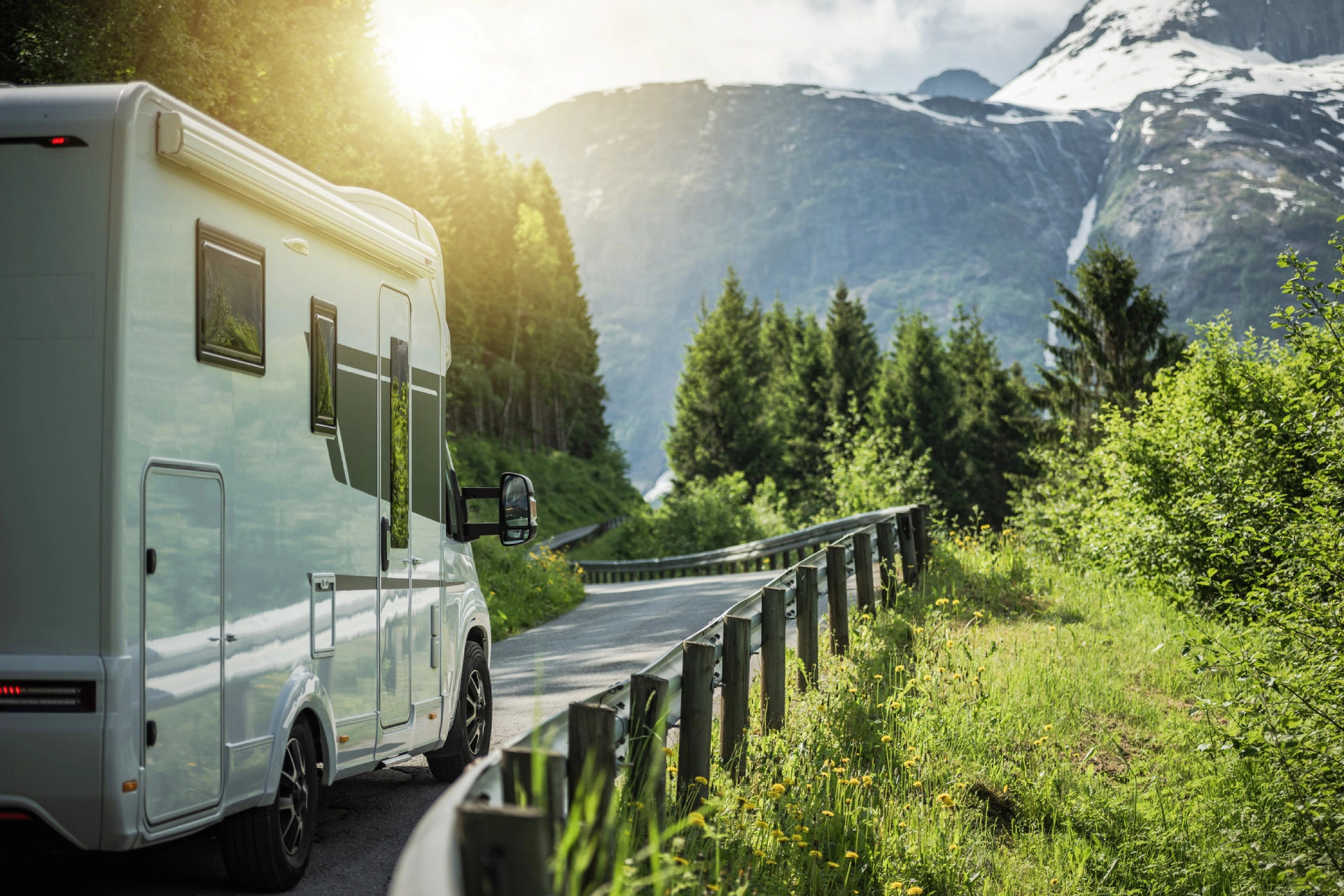 Modern Semi Integral Camper Van on the Scenic Norwegian Route During Hot Summer Day